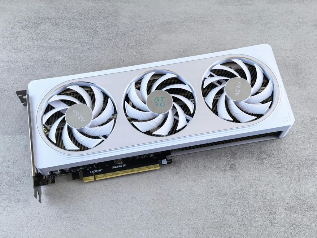 Stylish white graphics card with three cooling fans on a neutral background, ideal for tech enthusiasts.