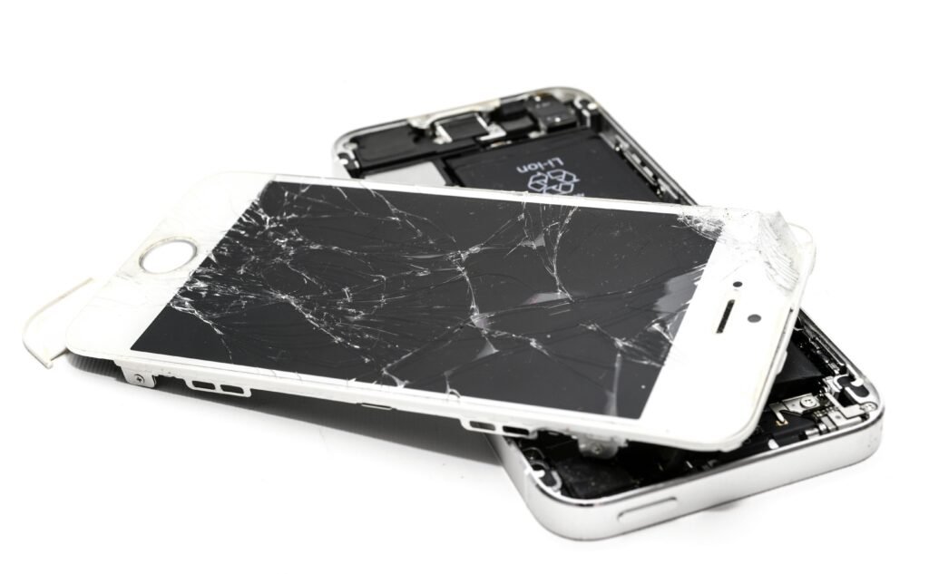 Dropped Your Phone? The Ultimate Guide to iPhone Screen Repair in Macclesfield Close-up of a broken smartphone with a severely cracked screen.