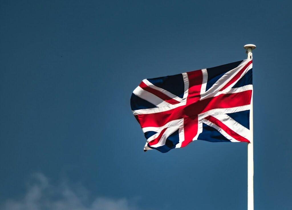 Don’t Let Your Tech Crash Tonight! Getting Your Screen Ready for England vs DR Congo a flag flying in the wind on a clear day